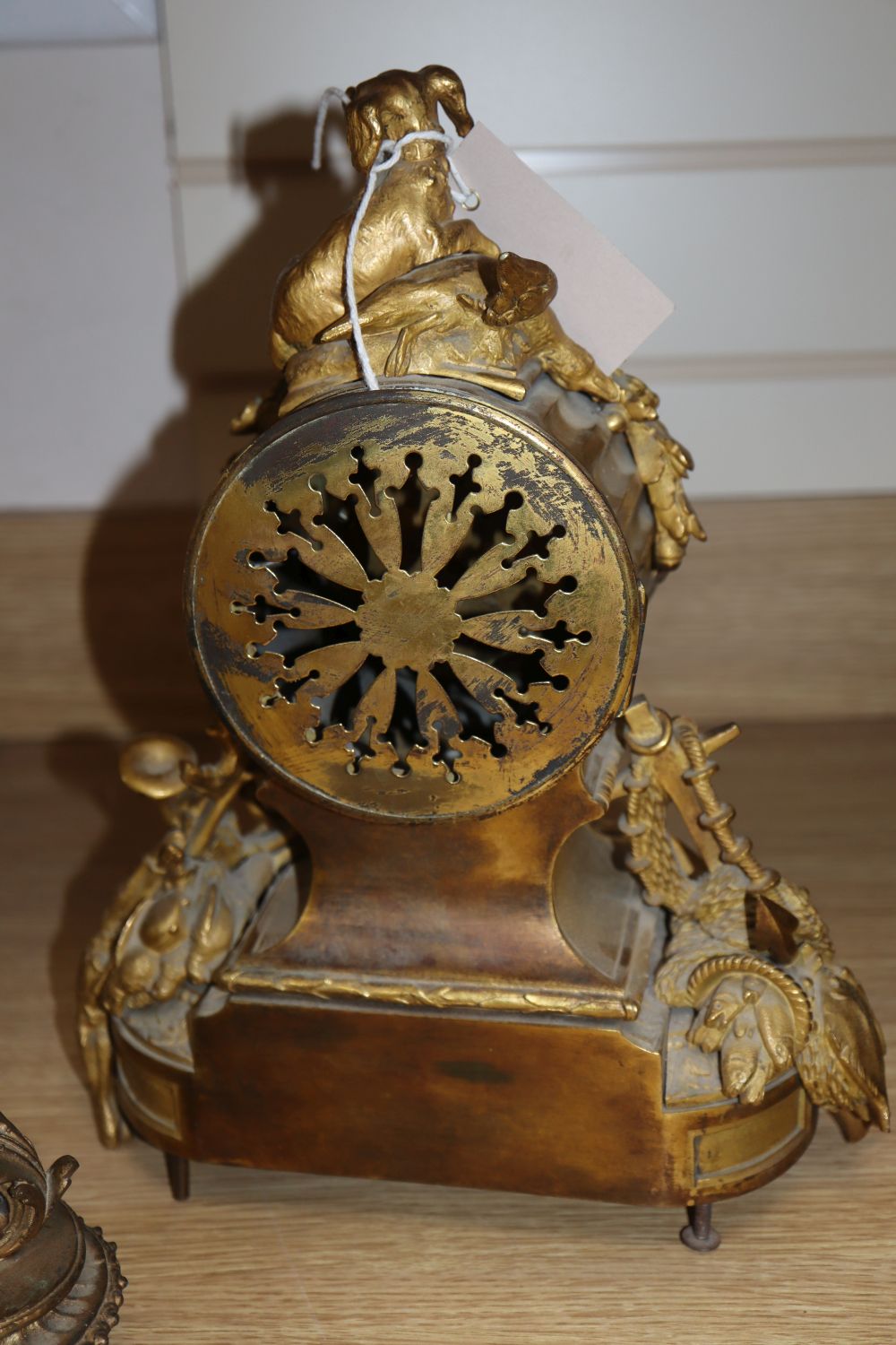 A 19th century French Louis XVI style ormolu mantel clock and a pair of associated spelter table lamps,